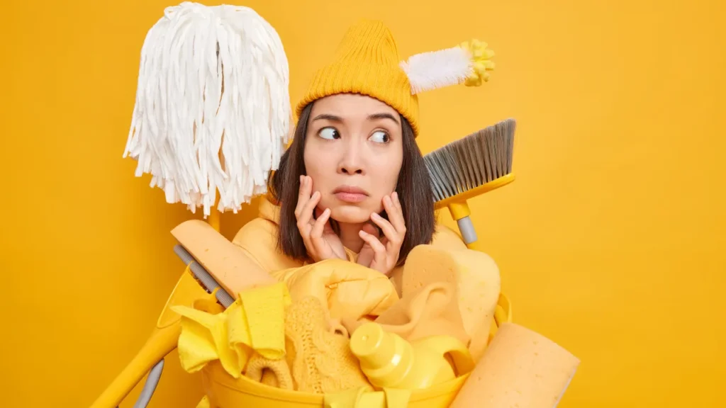 Person surrounded by cleaning supplies